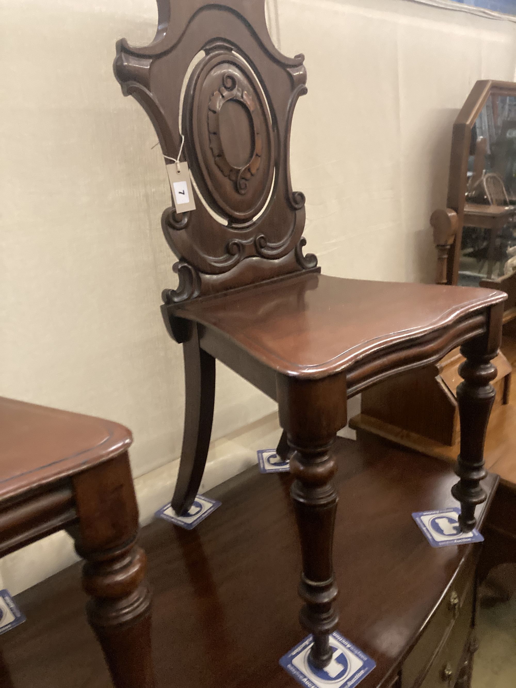 A pair of Victorian mahogany hall chairs